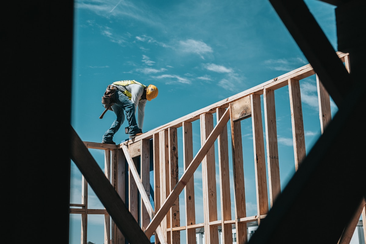 Builder framing a new house wall
